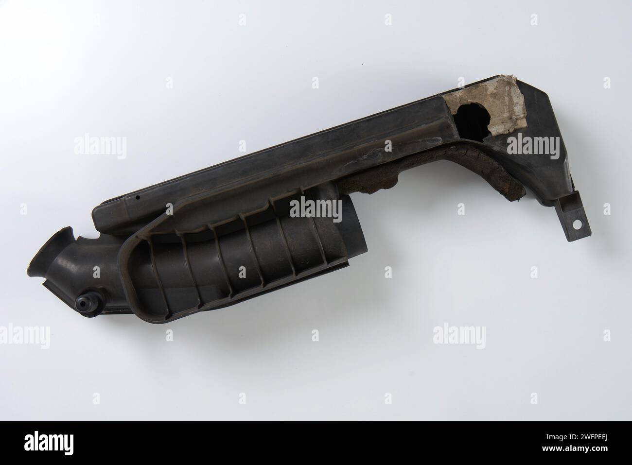 a broken air filter pipe from a car engine that needs to be replaced