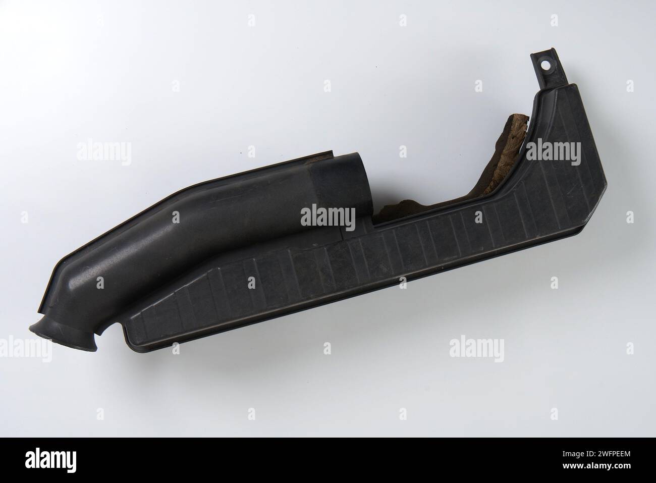 an air filter pipe from a car engine that needs to be replaced Stock