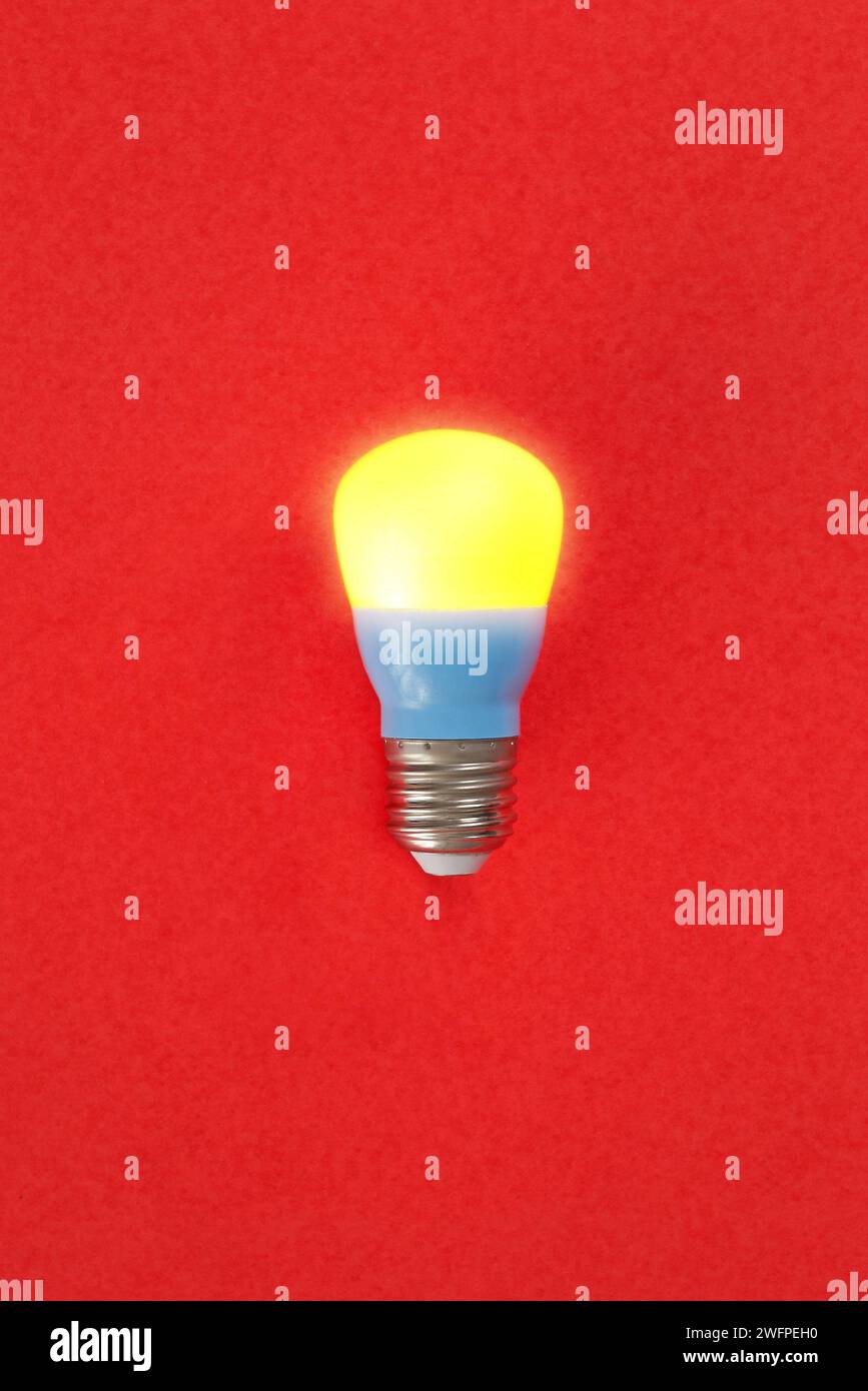 An interesting color composition between burning light bulbs and a red background Stock Photo