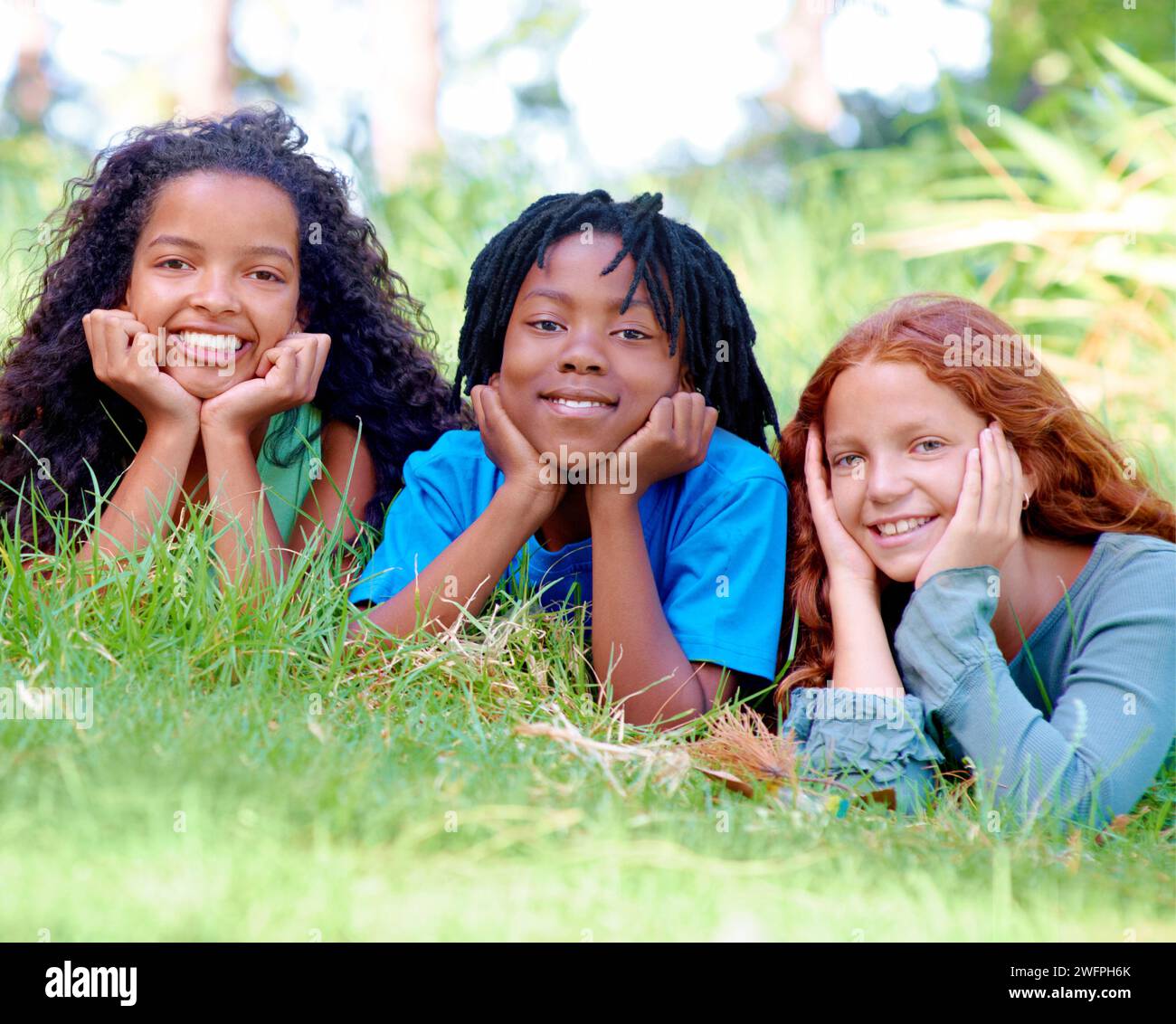 Nature, smile and portrait of kids on grass in outdoor park, field or