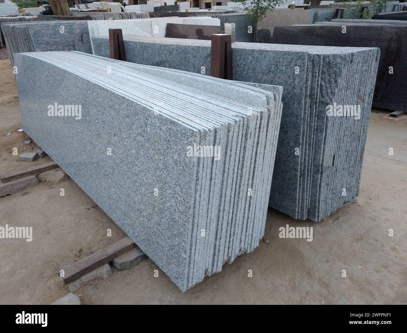 A stack of granite blocks in a yard Stock Photo