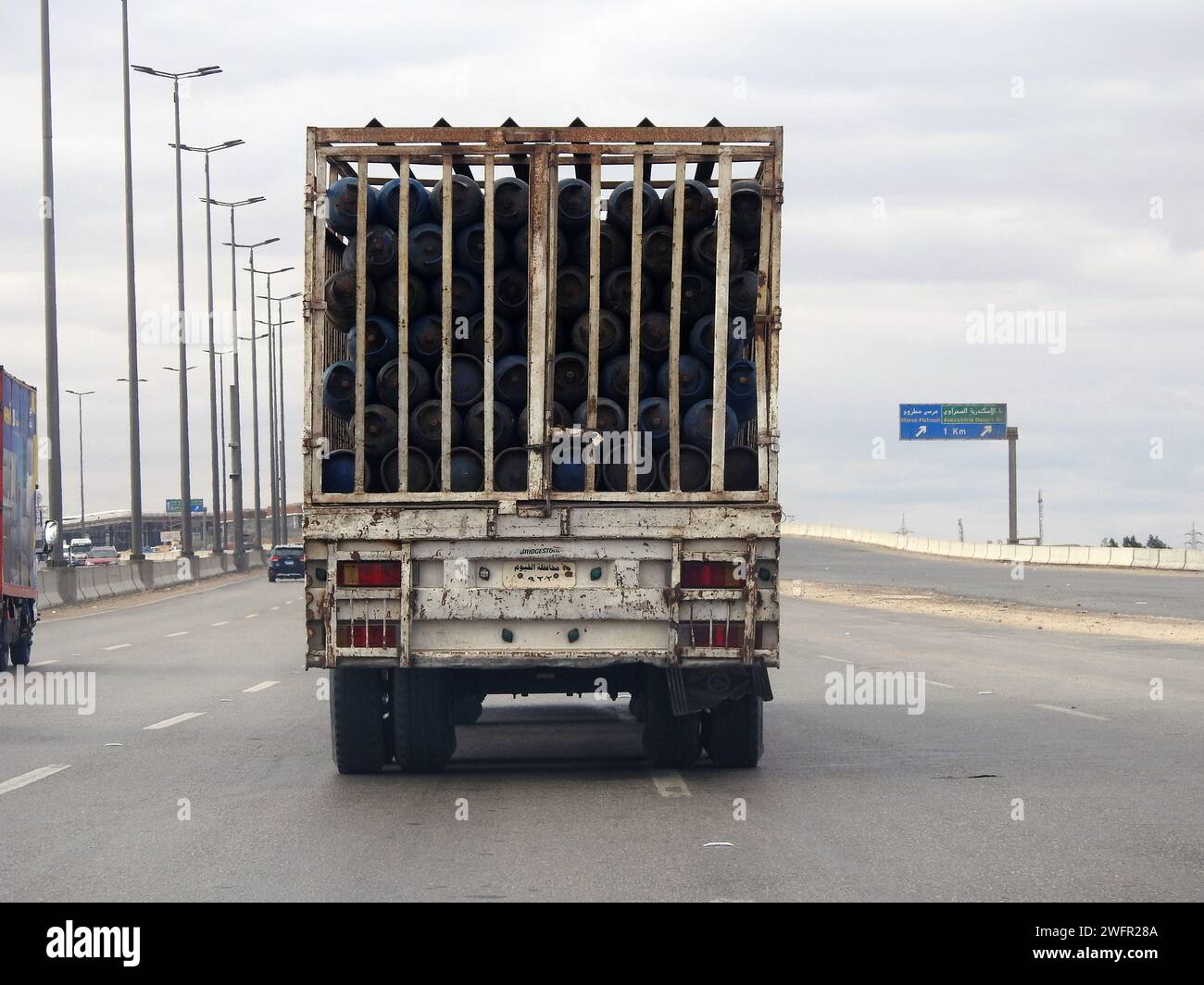 Giza, Egypt, January 25 2024: A transportation heavy truck lorry with gas cylinders, gas cylinder is a pressure vessel for storage and containment of Stock Photo