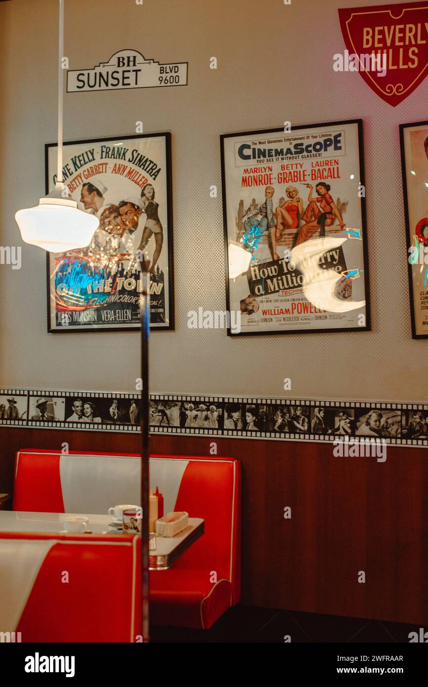 Interior in the 50s in American style with posters on the wall and red sofas Stock Photo
