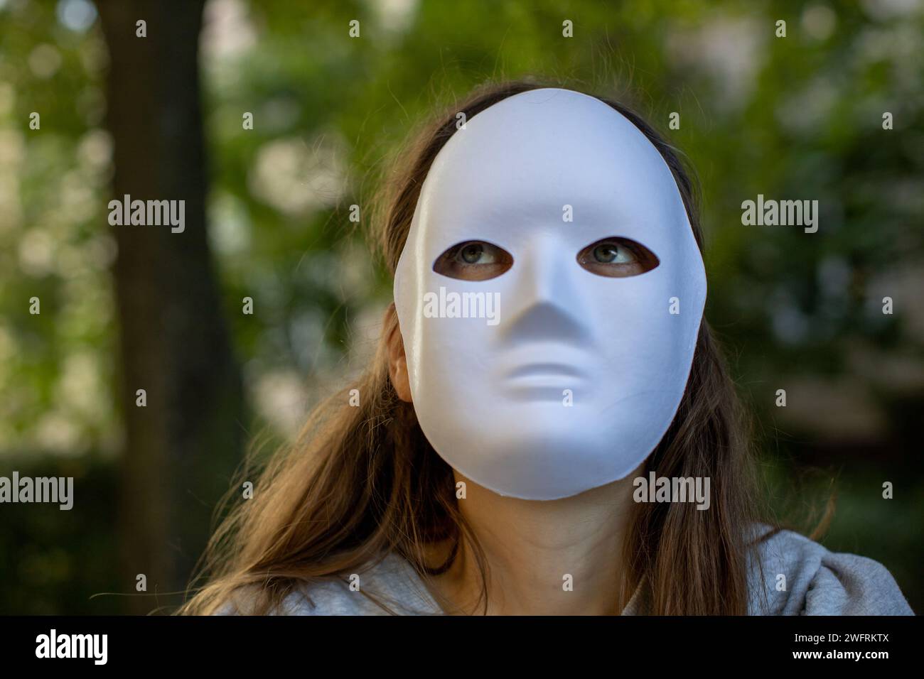 woman with full face white mask sitting in the woods Stock Photo - Alamy