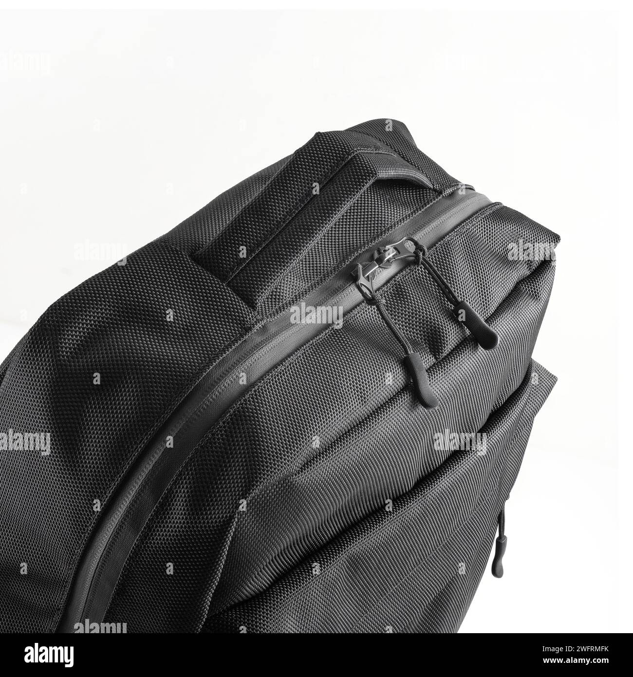 Black backpack with handle and compartments on a zipper. Rucksack for