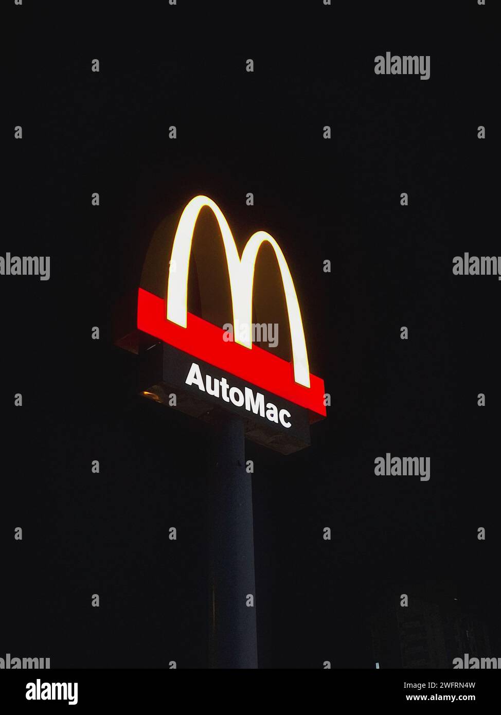 A vertical of McDonald's sign at night Stock Photo - Alamy