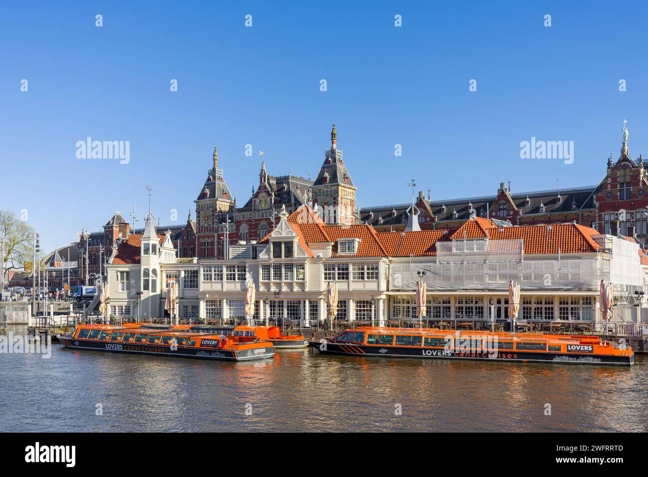 Pleasure Cruisers moored up on a canal in Amsterdam, North Holland, Netherlands. Stock Photo