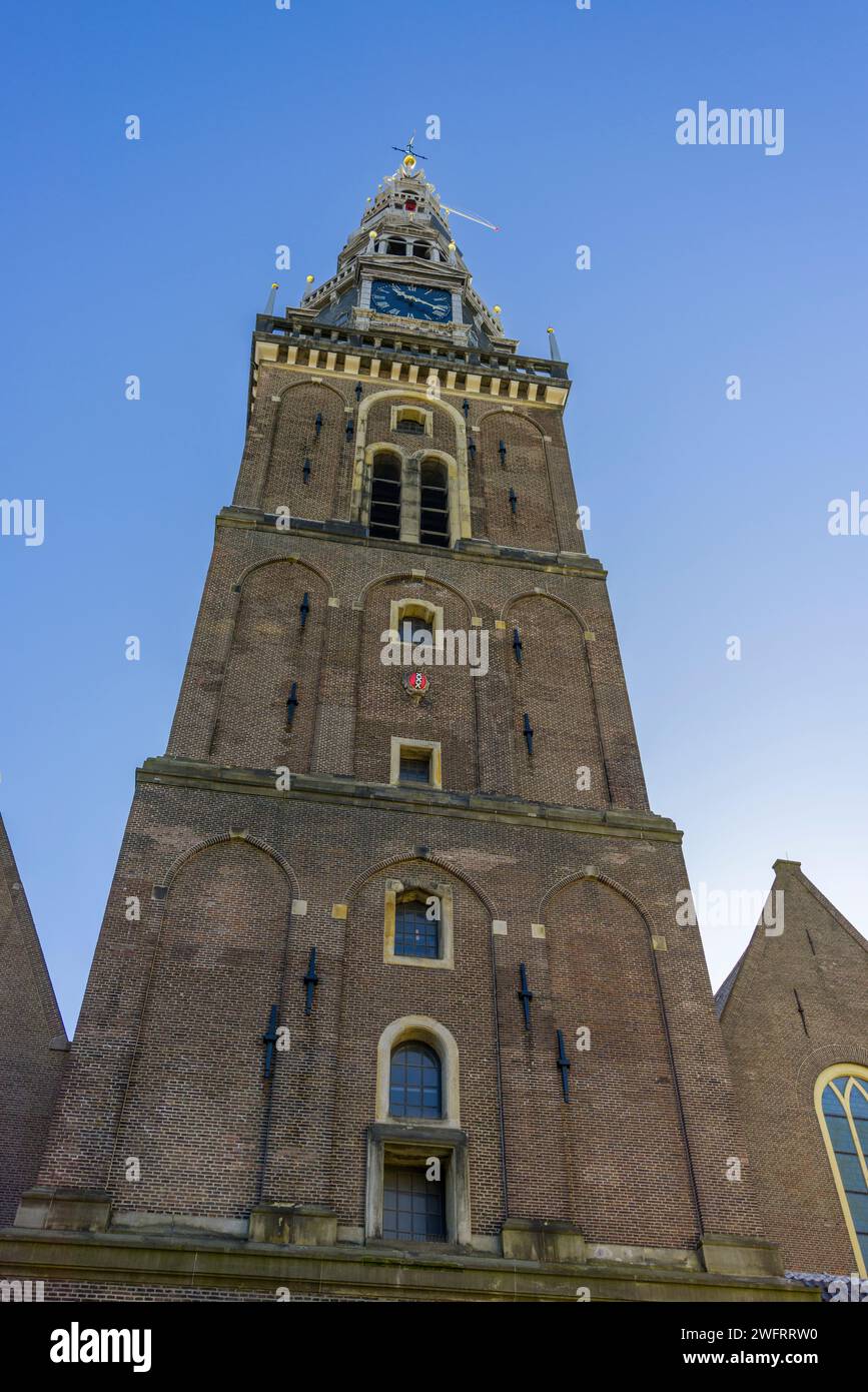 The tower of the Old Church (Oude Kerk), the oldest building in Amsterdam, North Holland, Netherlands. Stock Photo