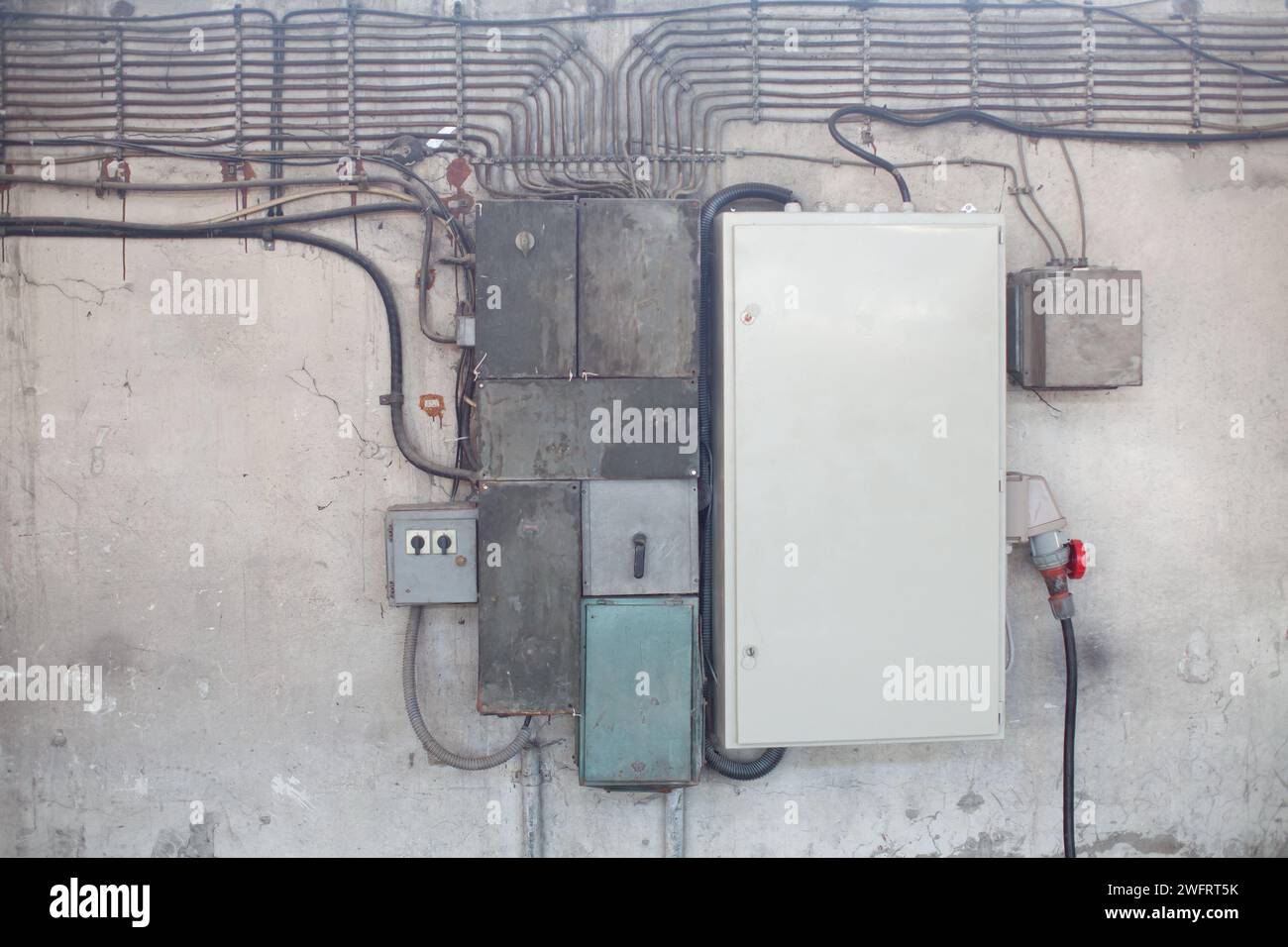 old electrical wires and transformers on the wall Stock Photo
