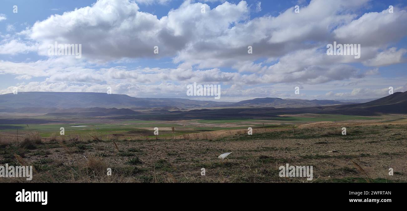 A lush valley seen with mountains in the background Stock Photo - Alamy