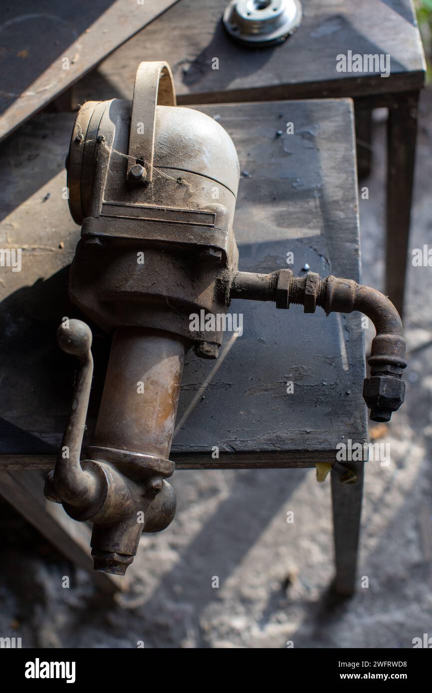 old machine part displayed in mechanic workshop Stock Photo