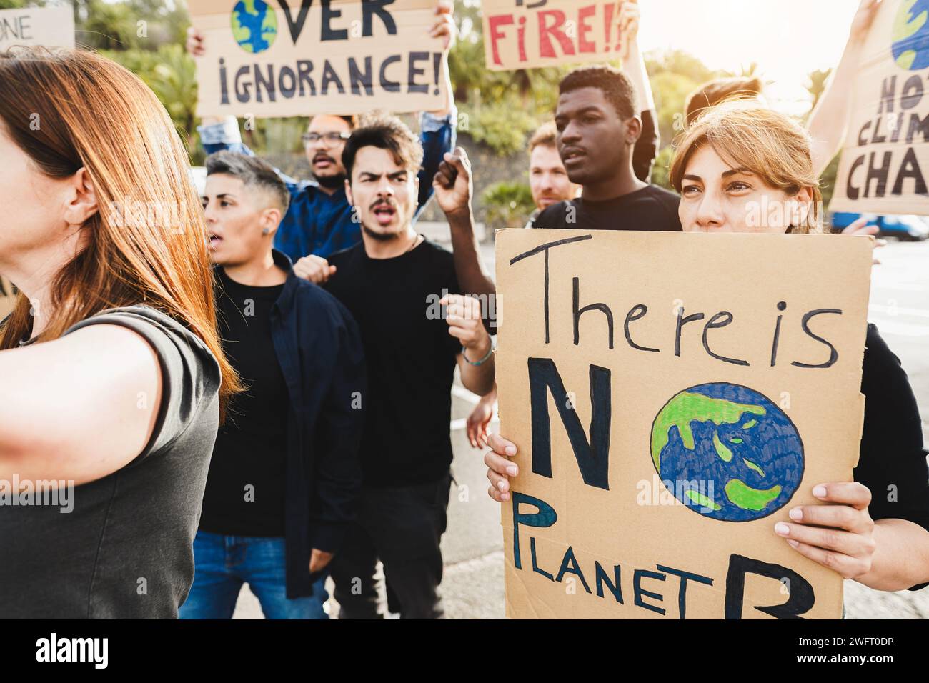 Multigenerational people protest against climate change - Crowd doing demonstration for stopping pollution - Green and environment concept - Focus on Stock Photo
