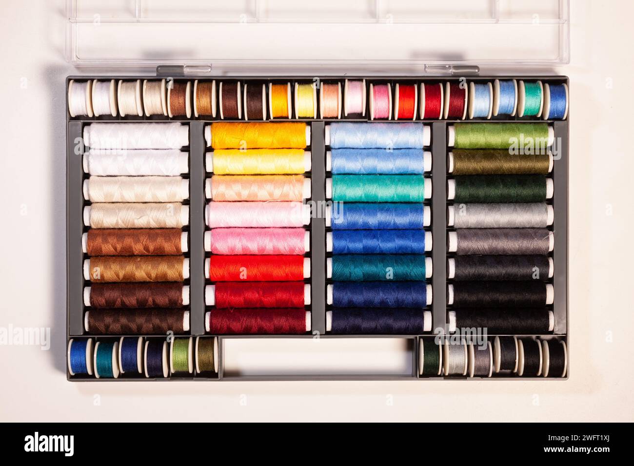 many colorful sewing threads on spools Stock Photo