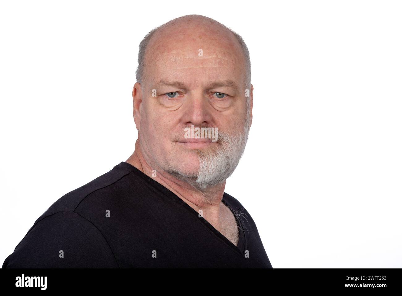 Focused Middle-Aged Man with Half Shaved Beard in Stylish Black T-Shirt - Confident Portrait on White Background Stock Photo