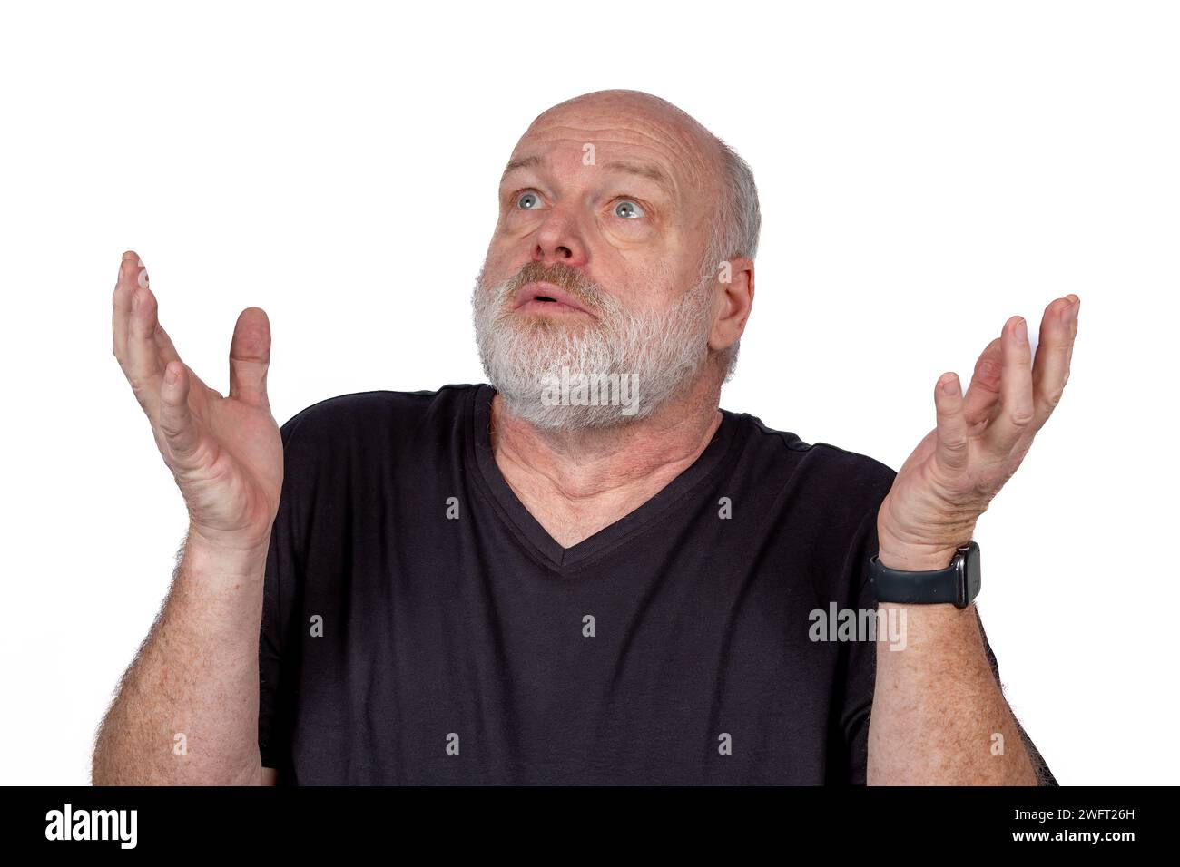 Surprised Middle-Aged Bearded Man in Black T-Shirt with Hands Up, Astonished Expression, White Background - Authentic Emotion and Excitement Concept Stock Photo