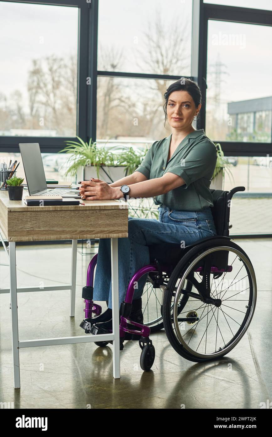 joyous disabled businesswoman in casual attire in wheelchair looking at ...