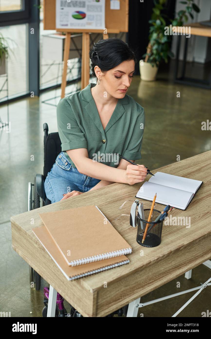 good looking businesswoman with disability sitting in wheelchair while ...