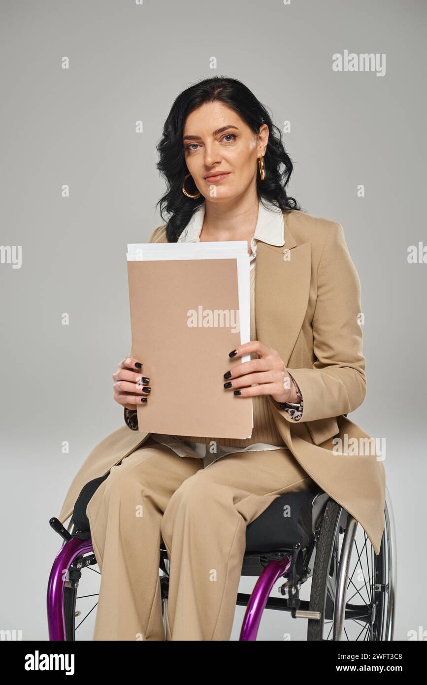 attractive jolly confident woman with disability holding her paperwork ...