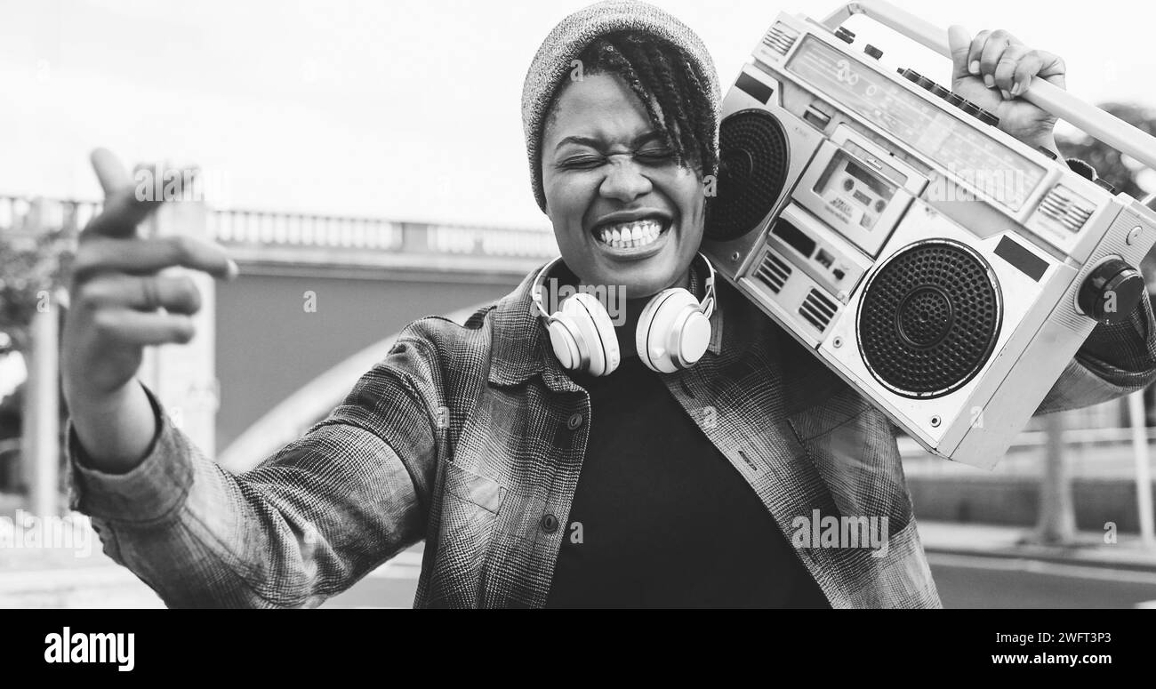 African american woman singing underground music holding boombox vintage stereo - Urban lifestyle concept - Soft focus on face Stock Photo
