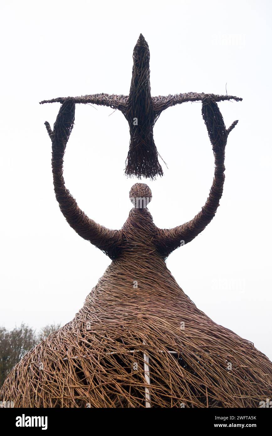 Sculpture of woman releasing bird (a peace dove perhaps), made from willow tree branches, by Willowtwisters artist in residence, on display at Runnymede, Surrey. UK. Stock Photo