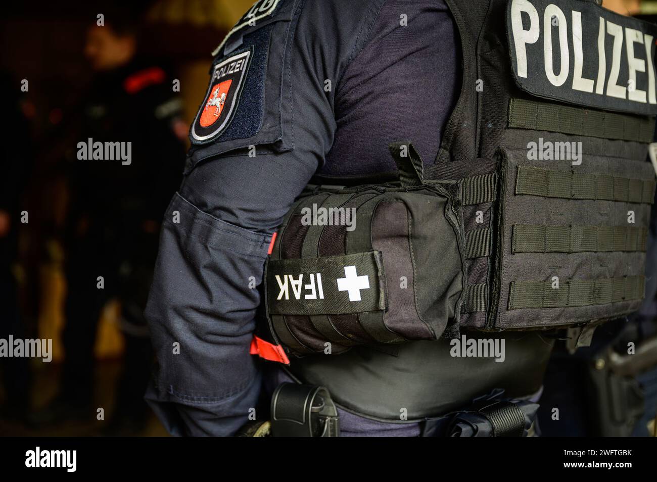 PRODUCTION - 03 January 2024, Lower Saxony, Hohenbostel: A police officer from Lüneburg wears an Individual First Aid Kit (IFAK) on his protective vest. Photo: Philipp Schulze/dpa Stock Photo