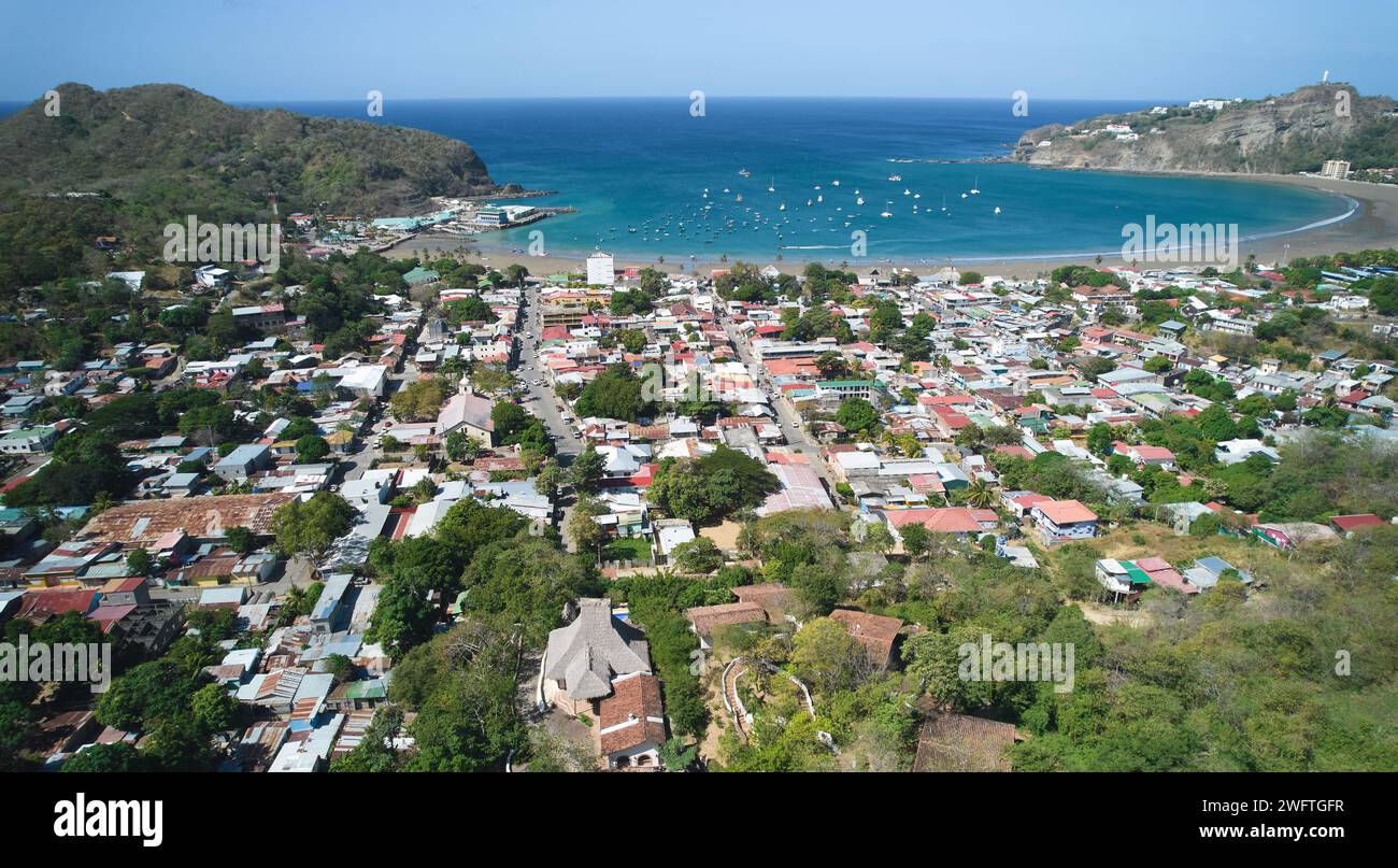 Small town next to ocean bay aerial above drone view Stock Photo