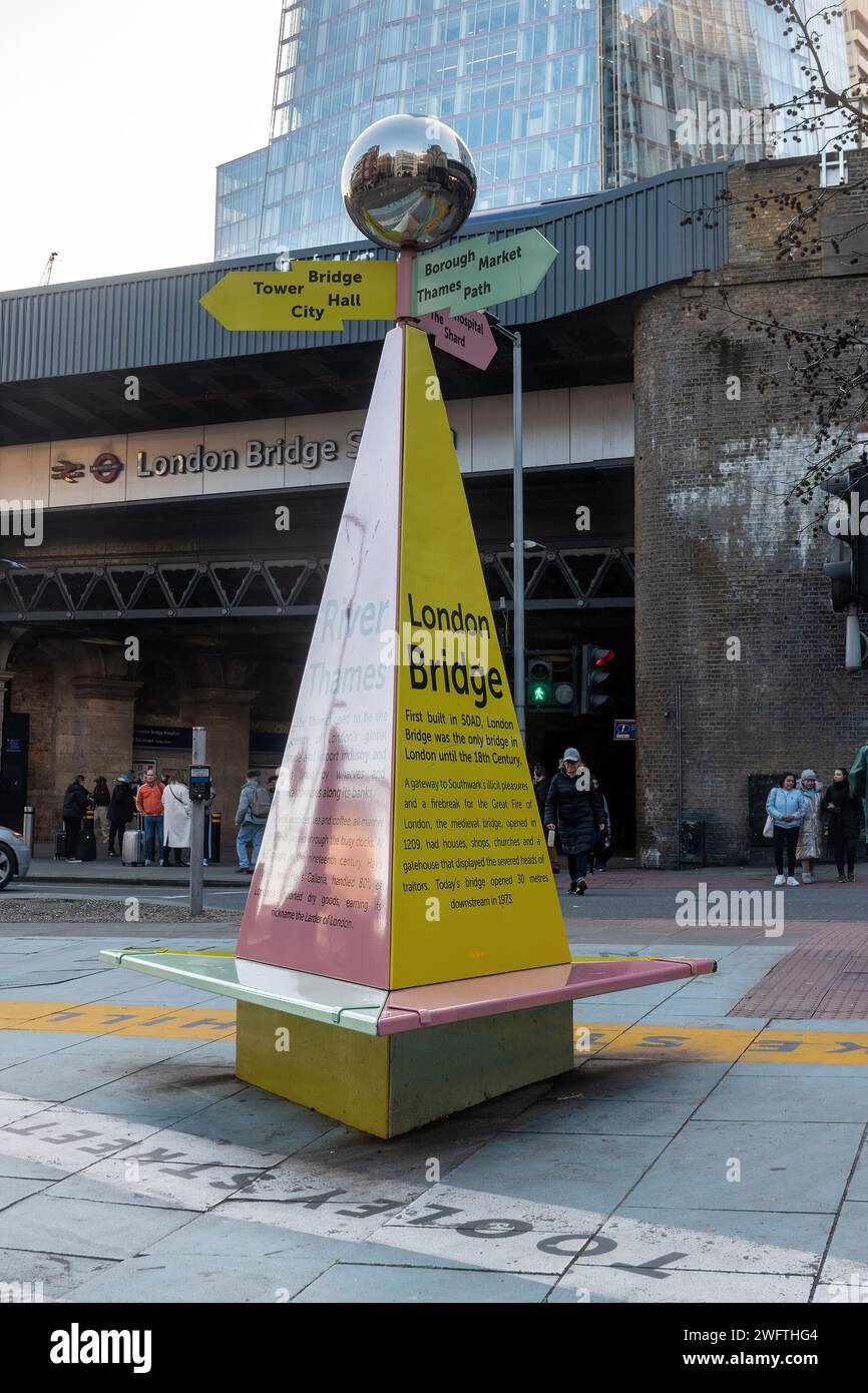 Tooley Street Triangle, street art and large signpost outside London Bridge Station with a bench and local history information, London, England, UK Stock Photo