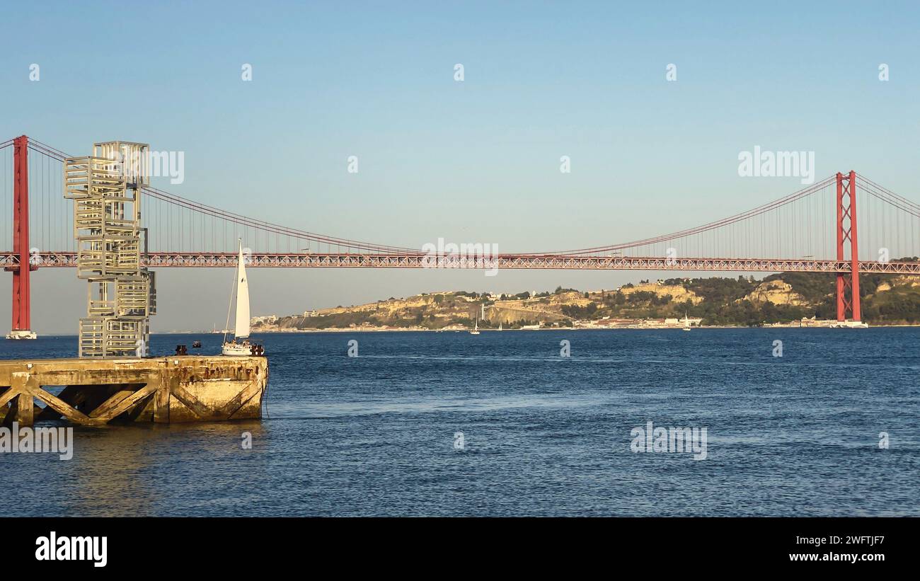 A panoramic view of famous Ponte 25 de Abril bridge in Lisbon over river Tagus in Portugal Stock Photo