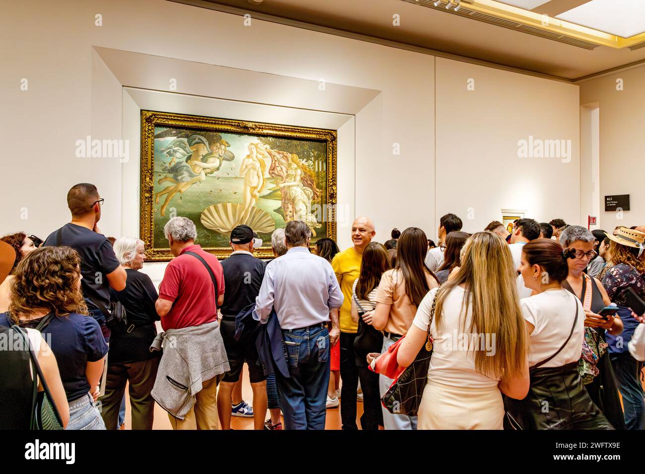 Large crowds of people viewing  The Birth Of Venus by Botticelli at The Uffizi Gallery ,one of the world's top art museums in Florence ,Italy Stock Photo