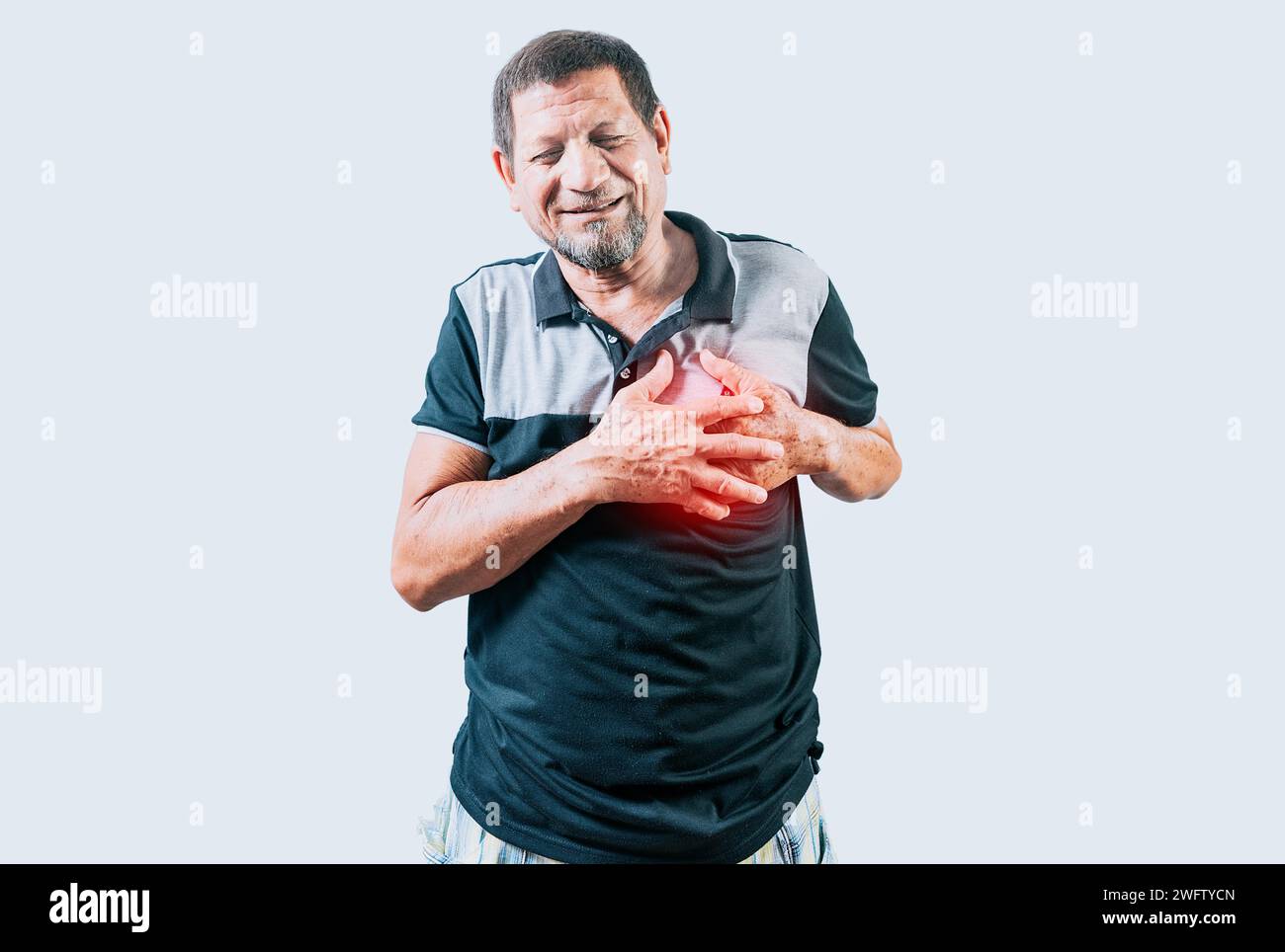 Elderly person with heart problems. Senior man with tachycardia touching his chest. Old man with heart pain touching chest isolated Stock Photo