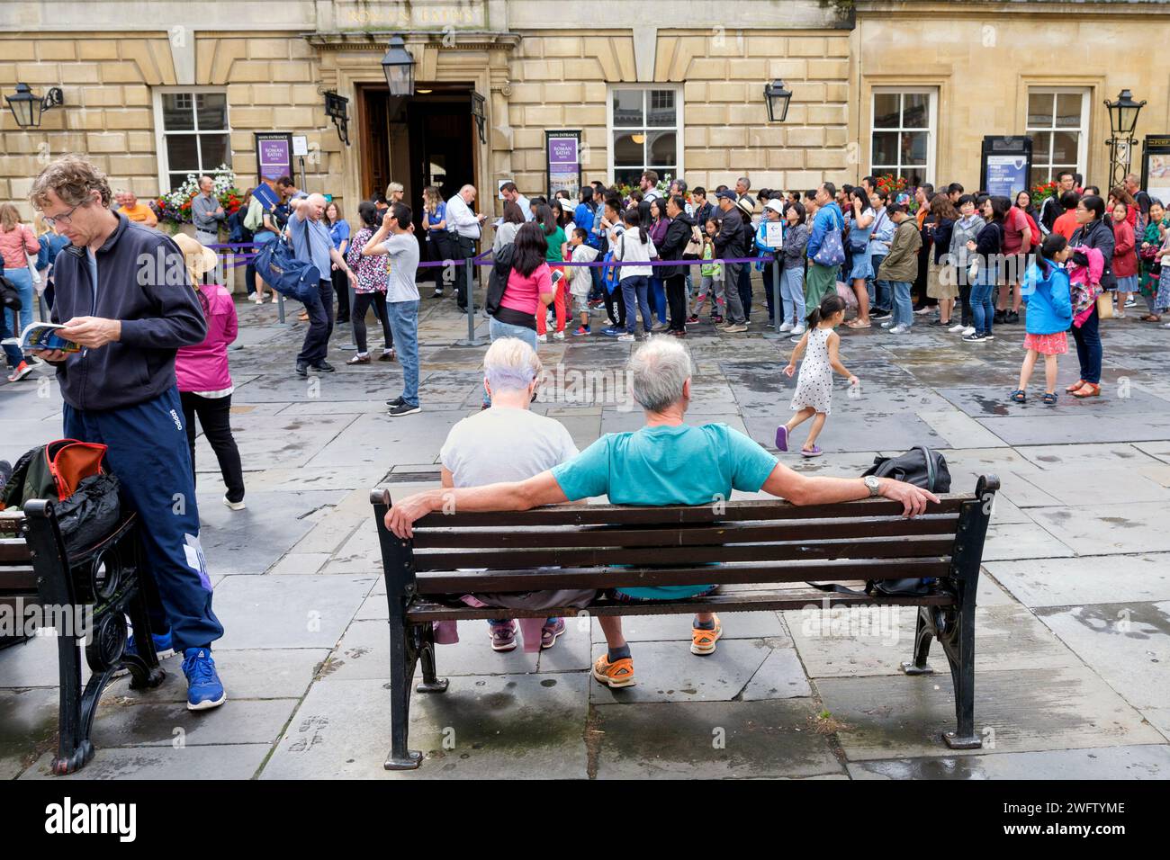 Tourists are pictured queueing to get into the World famous Bath Pump