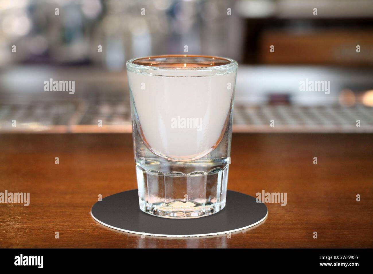 Ouzo or raki - traditional balkan anise strong alcoholic drink on table close-up. Stock Photo