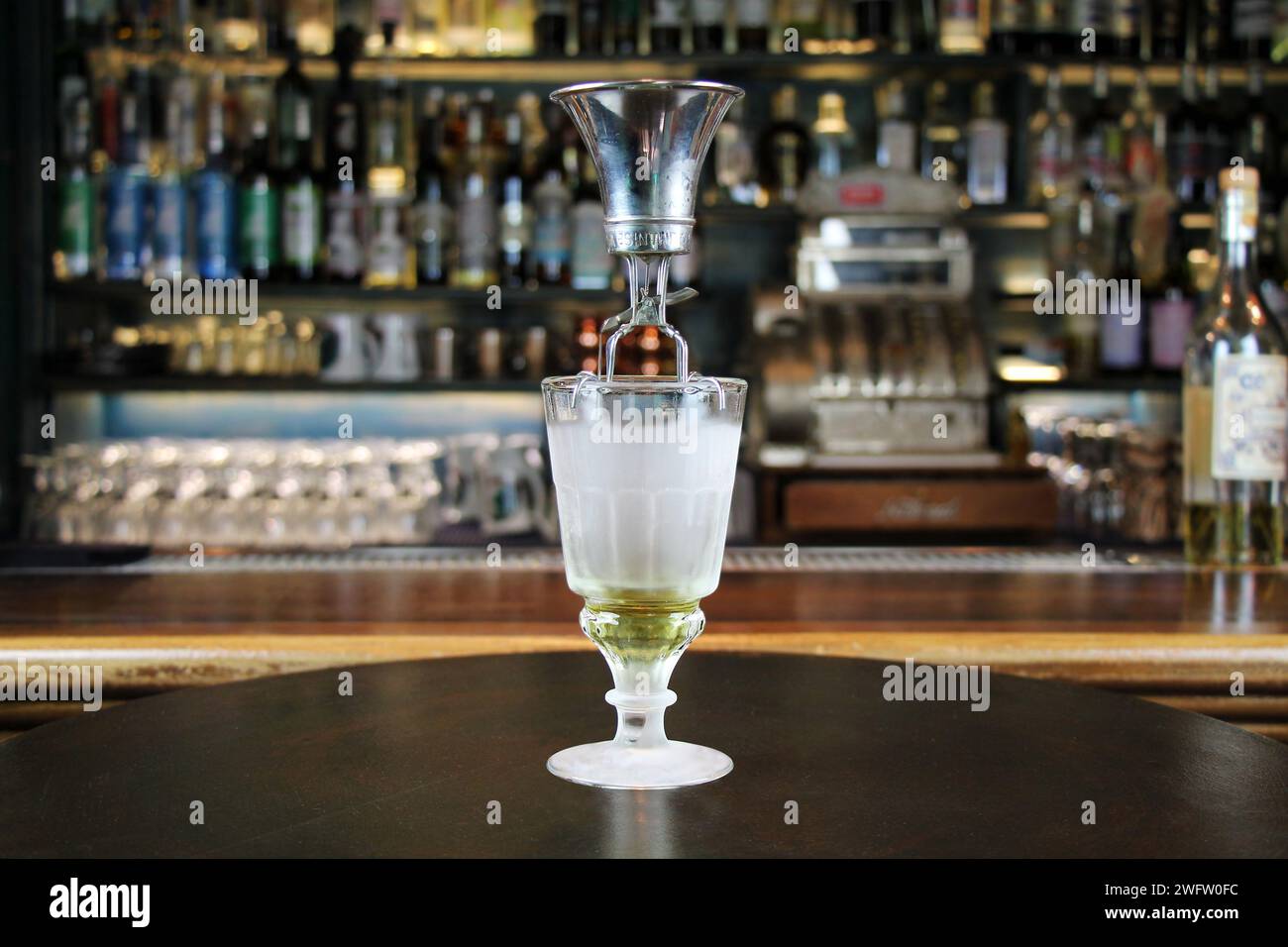 Classic type of absinthe preparation with brouiller (a tool for