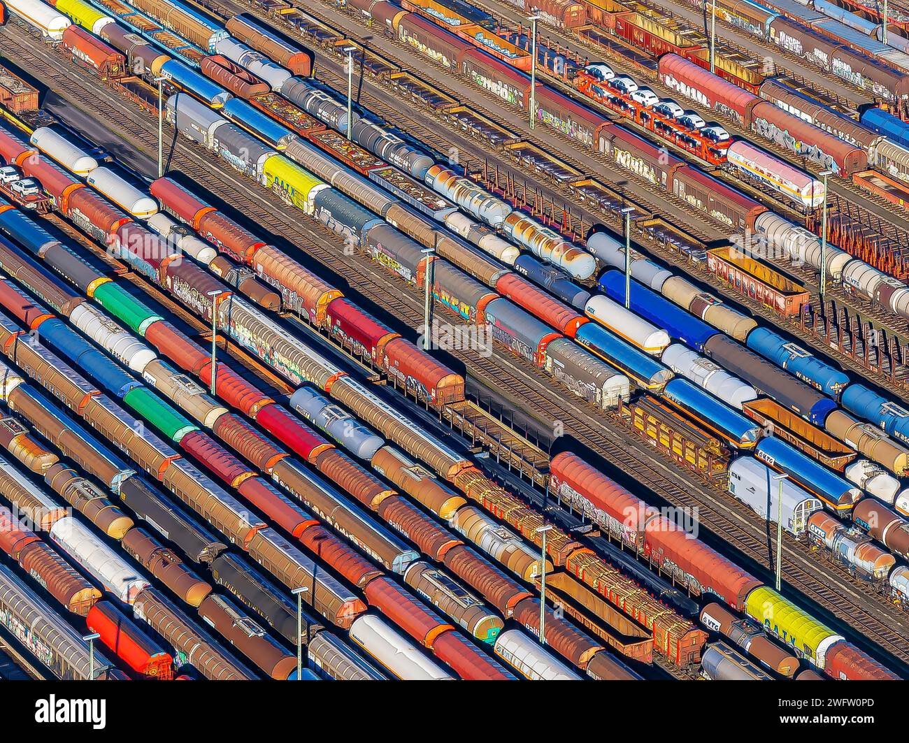 Deutsche Bahn AG marshalling yard. Many goods trains are parked on the tracks with tank wagons, car transporters and other wagons, companies Stock Photo