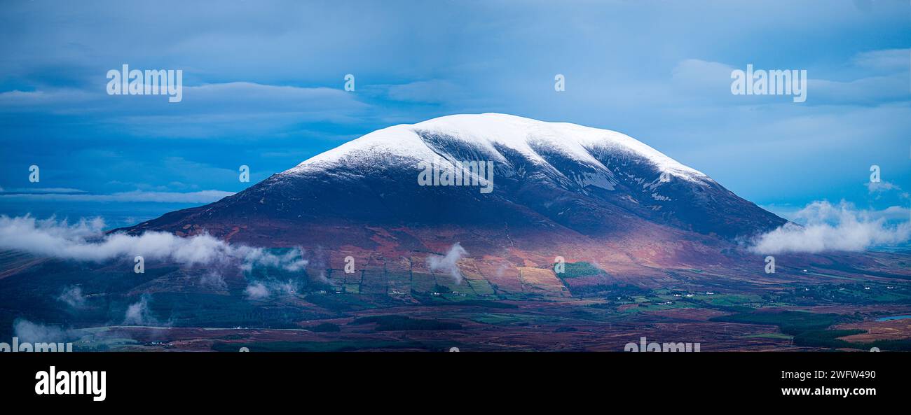 Snow on Nephin mountain dramatic sky low clouds Ireland Stock Photo