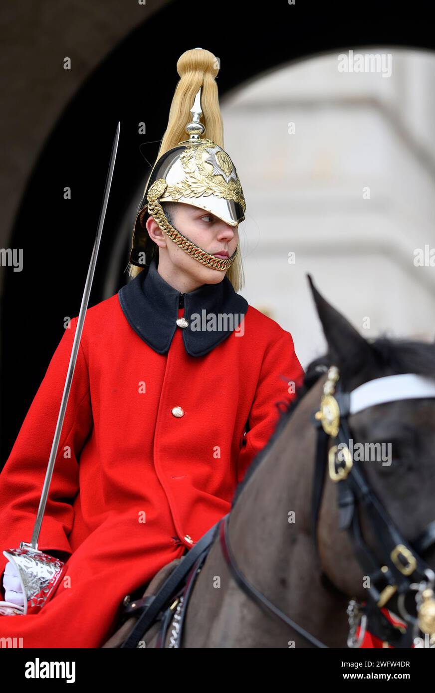 London, UK. Female member of the Household Cavalry (Lifeguards) leaving at the end of her duty at the entrance to Horse Guards Stock Photo