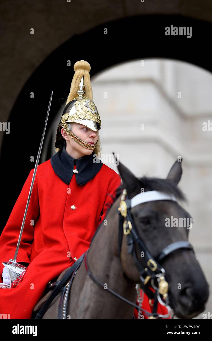 London, UK. Female member of the Household Cavalry (Lifeguards) leaving at the end of her duty at the entrance to Horse Guards Stock Photo