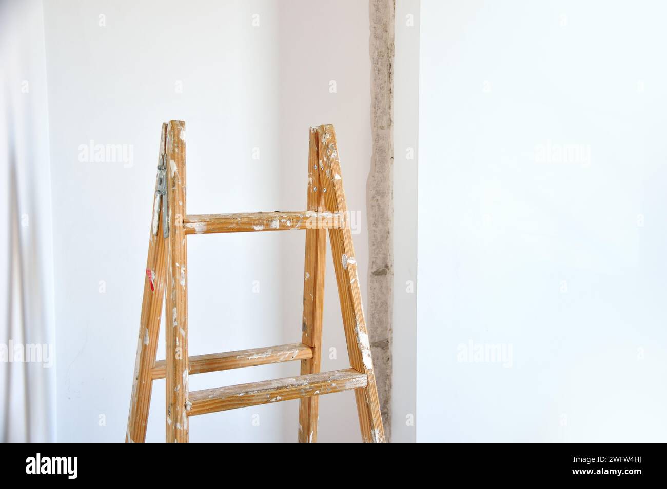 close-up of a wooden ladder and a wall repairing background Stock Photo
