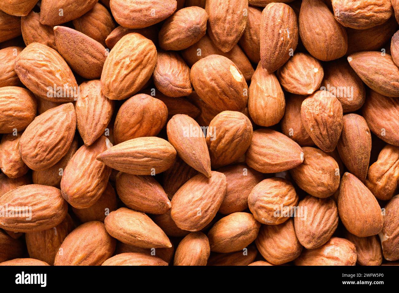 Pile of Raw Dry Almonds Background Texture. Stock Photo