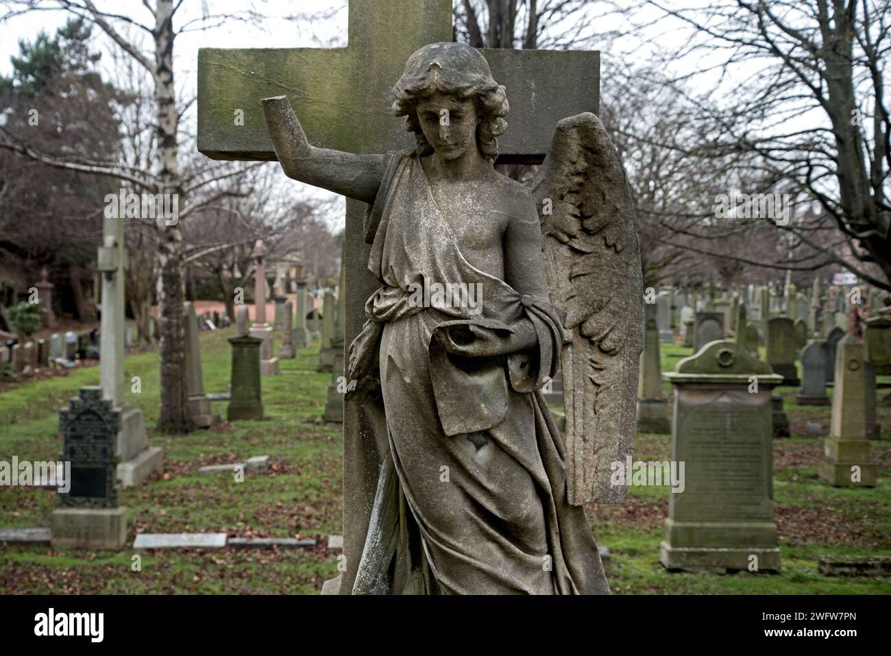 Figure of an angel with part of the arm broken off and a wing missing in the Grange Cemetery, Edinburgh, Scotland, UK. Stock Photo