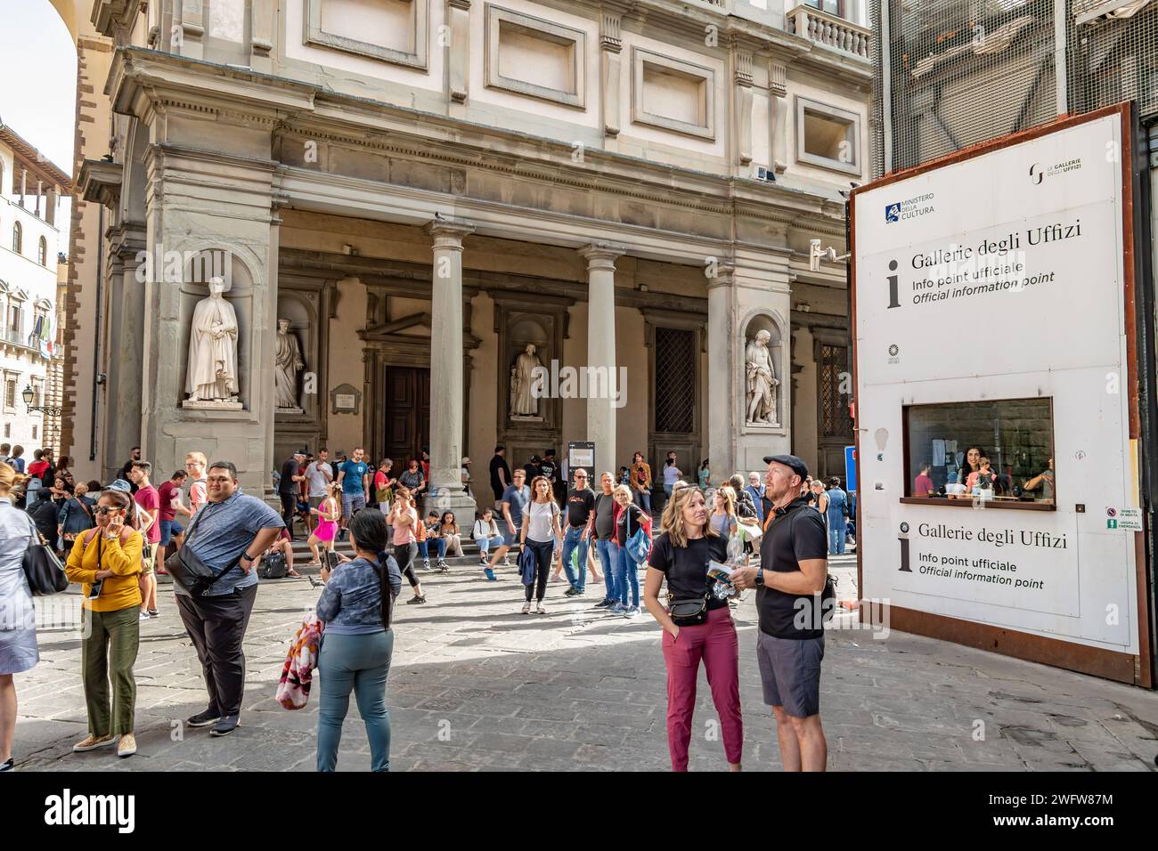 People standing near a visitor help kiosk at The Uffizi Gallery in Florence, Italy Stock Photo