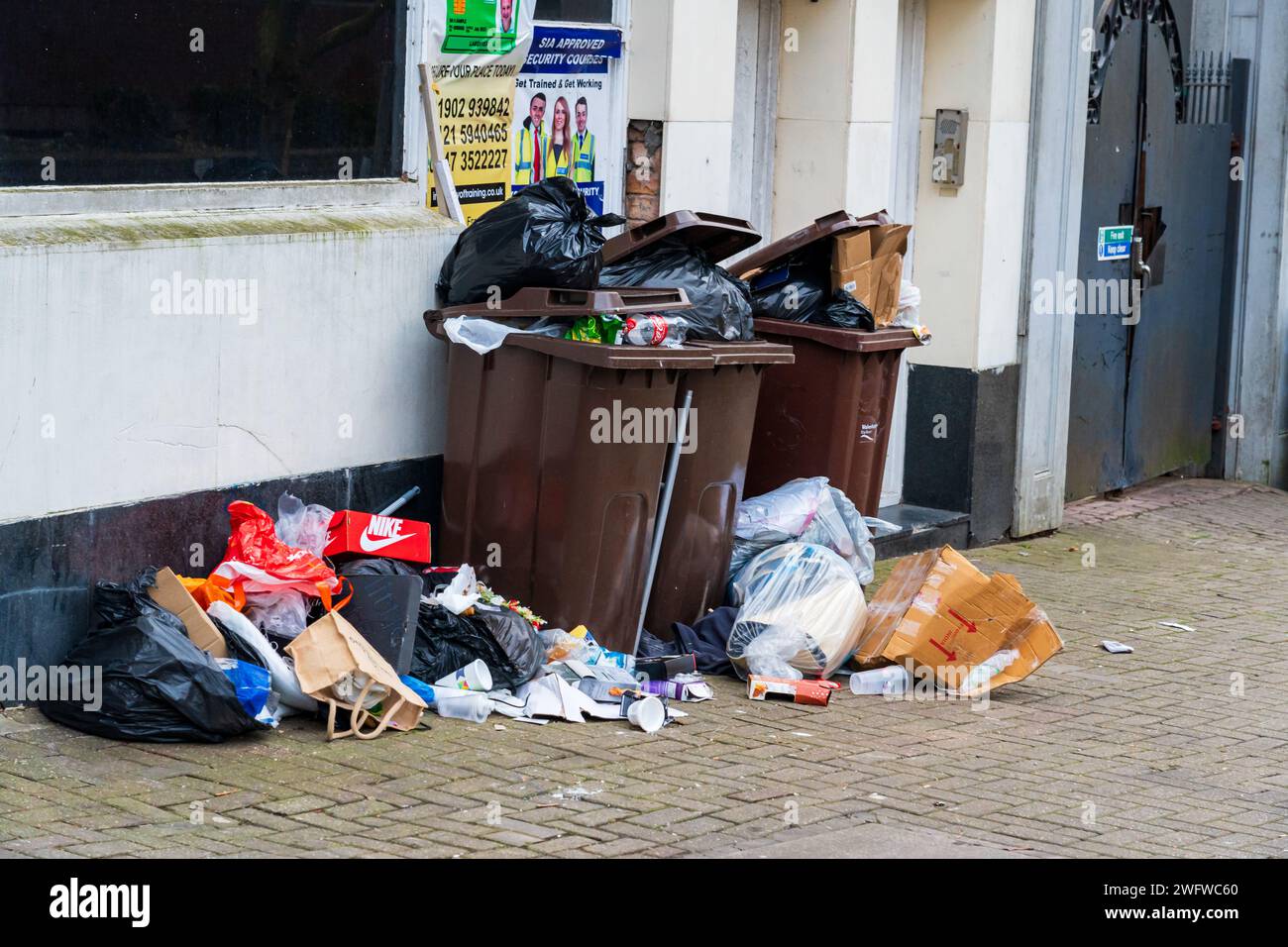 Wolverhampton, England – January 31 2024:  Rubbish piling up outside of building Stock Photo