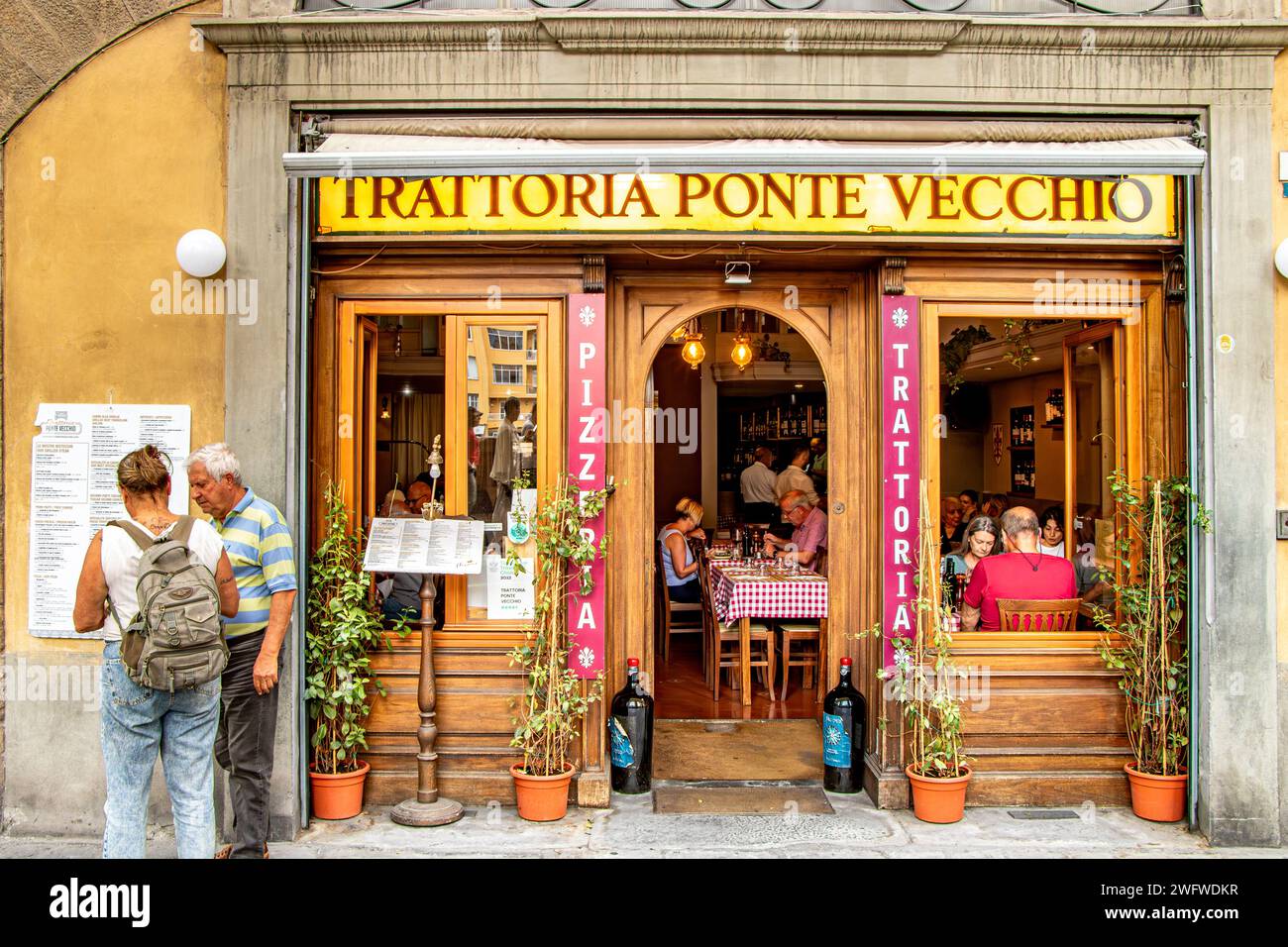 People enjoying food at Trattoria Ponte Vecchio on Lungarno degli Archibusieri, a restaurant in Florence ,Italy Stock Photo