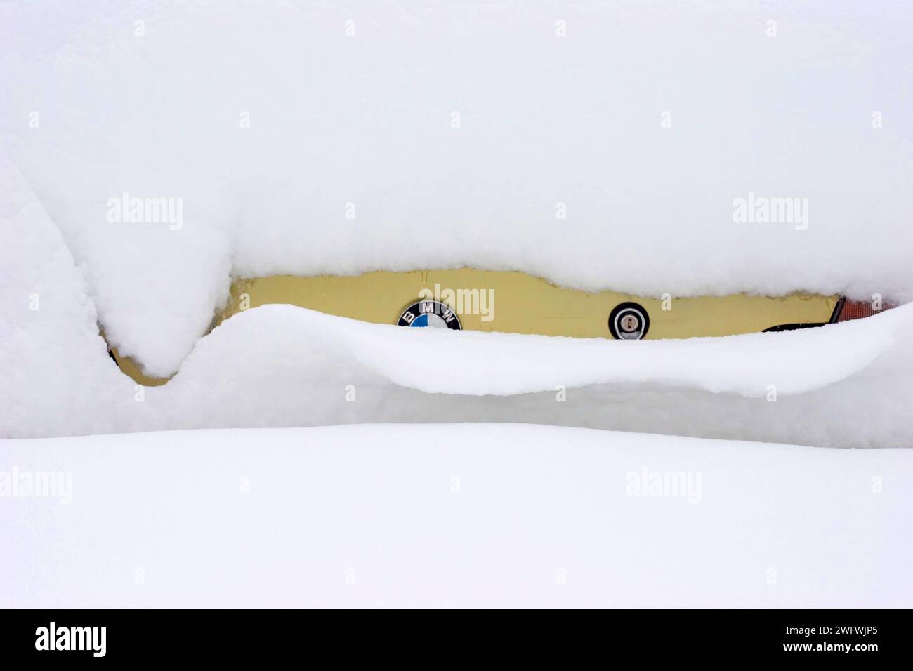 a BMW completely covered in snow Stock Photo
