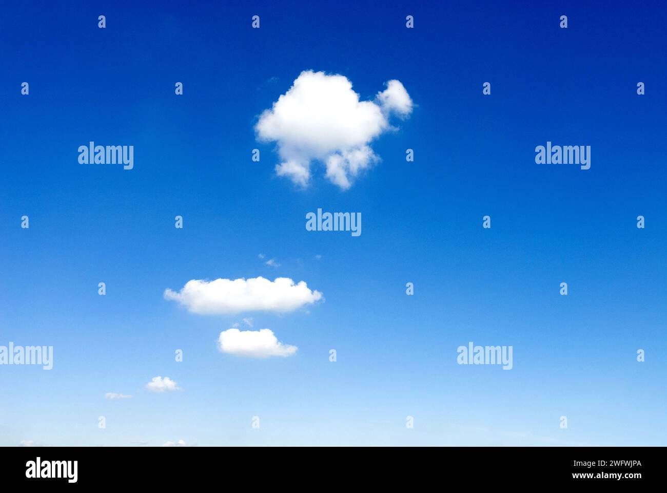 a small cumulus cloud in the blue sky Stock Photo