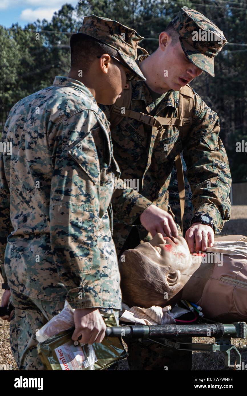 U.S. Marine Corps Sgt. Coleman Grubbs, a maintenance management specialist with 24th Marine Expeditionary Unit (MEU), and Florida native, treats a simulated casualty during a casualty field exercise as part of Realistic Urban Training (RUT) on Fort Barfoot, Virginia, January 13, 2024. RUT provides the 24th MEU the opportunity to operate in unfamiliar environments, integrate the units of the Marine Air Ground Task Force, and train towards being designated as special operations capable. Stock Photo