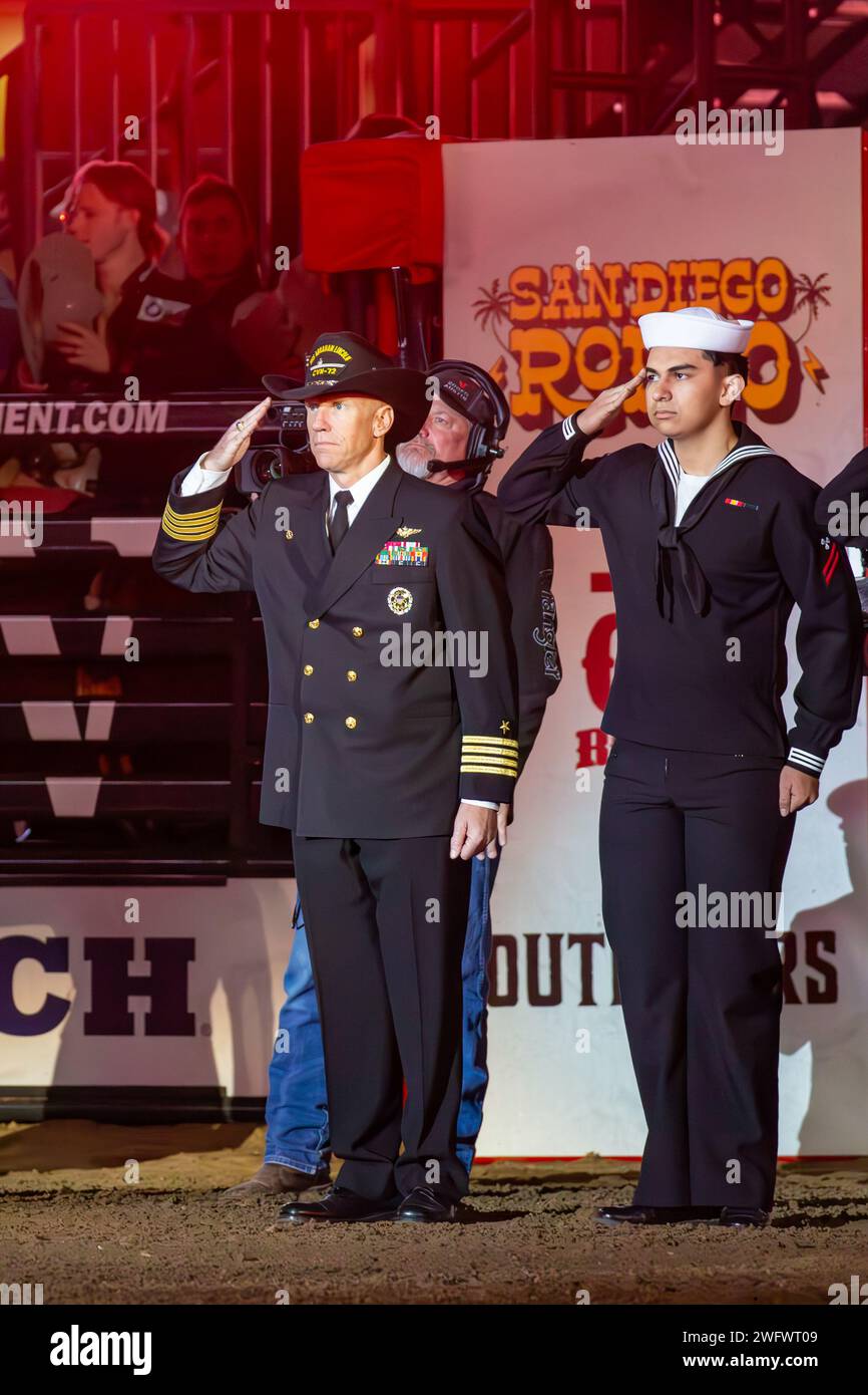 240112-N-YF131-1147 SAN DIEGO (Jan. 12, 2023) Capt. Pete Riebe, left, commanding officer of the Nimitz-class aircraft carrier USS Abraham Lincoln (CVN 72), salutes during the national anthem with Machinist’s Mate Fireman Apprentice Bryan Alarcon-Chavez, from Merced, Calif., before the San Diego Rodeo at Petco Park. Abraham Lincoln is currently moored pierside at Naval Air Station North Island. Stock Photo