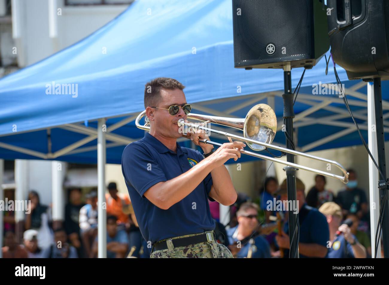 U.S. Navy Musician 3rd Class Aaron Wright, from Traverse City, Michigan, plays the trombone with the Pacific Partnership Band, comprised of members from the U.S. Pacific Fleet Band and Royal Australian Navy Band, at Chuuk High School during a host nation outreach event in Chuuk, Federated States of Micronesia, as part of Pacific Partnership 2024-1 Jan. 15, 2024. Pacific Partnership, now in its 19th iteration, is the largest multinational humanitarian assistance and disaster relief preparedness mission conducted in the Indo-Pacific and works to enhance regional interoperability and disaster res Stock Photo