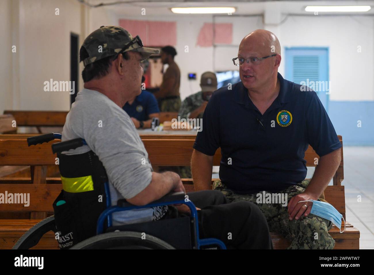 U.S. Navy Cmdr. Justin Nork, from Hazleton, Pennsylvania, speaks with a local patient at Chuuk State Hospital in Chuuk, Federated States of Micronesia, as part of Pacific Partnership 2024-1, Jan. 15, 2024. Pacific Partnership, now in its 19th iteration, is the largest multinational humanitarian assistance and disaster relief preparedness mission conducted in the Indo-Pacific and works to enhance regional interoperability and disaster response capabilities, increase security stability in the region, and foster new and enduring friendships. Stock Photo