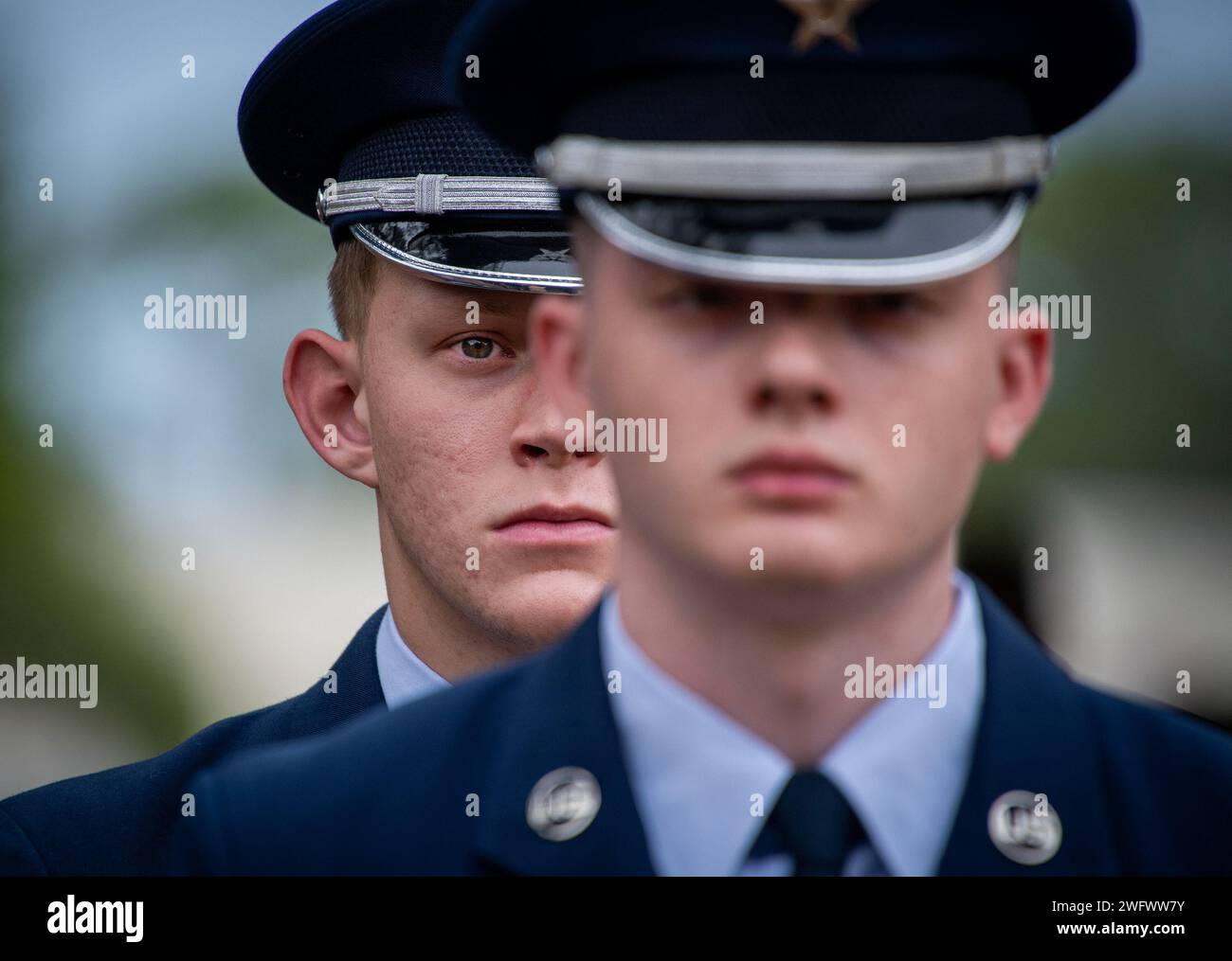 Senior Airman Dawson McCartney, 33rd Maintenance Squadron, waits to begin his part as a pallbearer prior to a full-honors funeral demonstration at the Honor Guard graduation ceremony Jan. 26, 2024 at Eglin Air Force Base, Fla. Approximately 13 new Airmen graduated from the 120-plus-hour course. The graduation demonstration includes flag detail, rifle volley, pallbearers and bugler for friends, family and leadership. Stock Photo